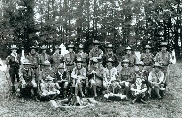 The first Wood Badge course, seated and standing around a campfire, Gilwell Park, 1919