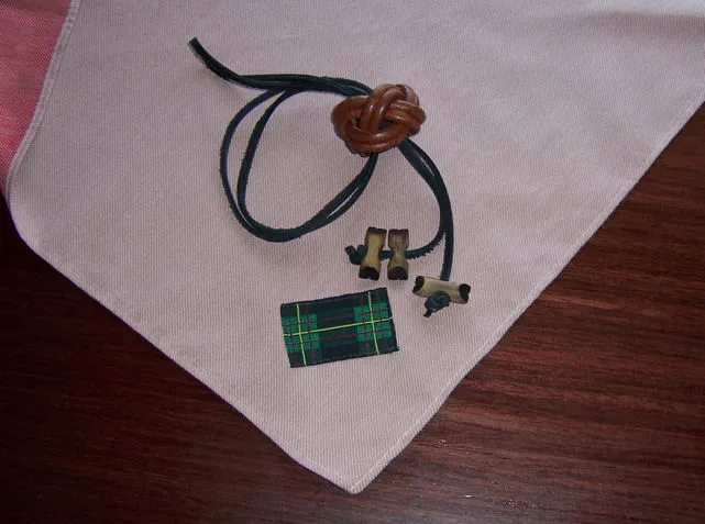 Wood Badge beads and woggle on a tan Gilwell neckerchief with its tartan patch